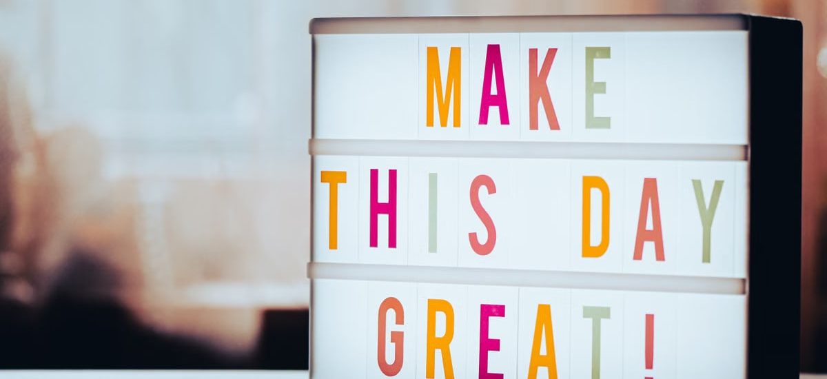 Lightbox displaying motivational message 'Make This Day Great!' in colorful letters against a blurred background.